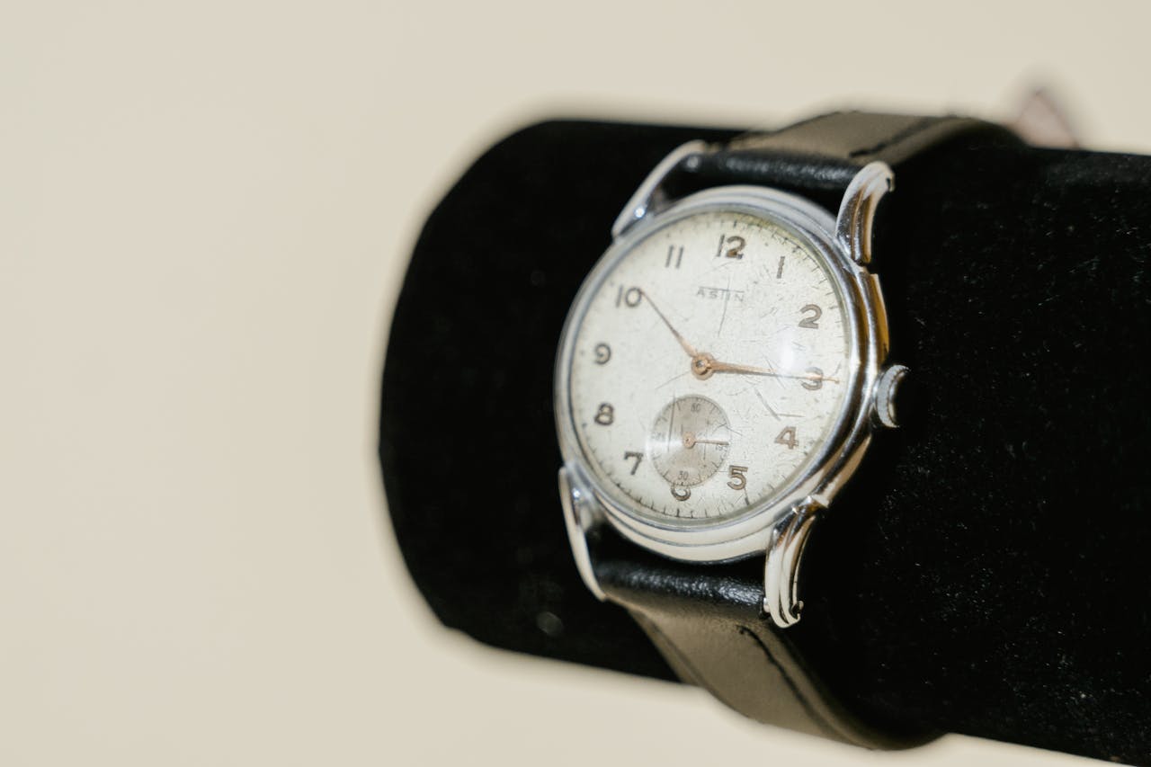Close-up of a vintage analog watch with a leather strap on display.